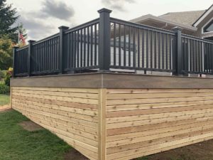 Close-up of a new deck with a black metal railing