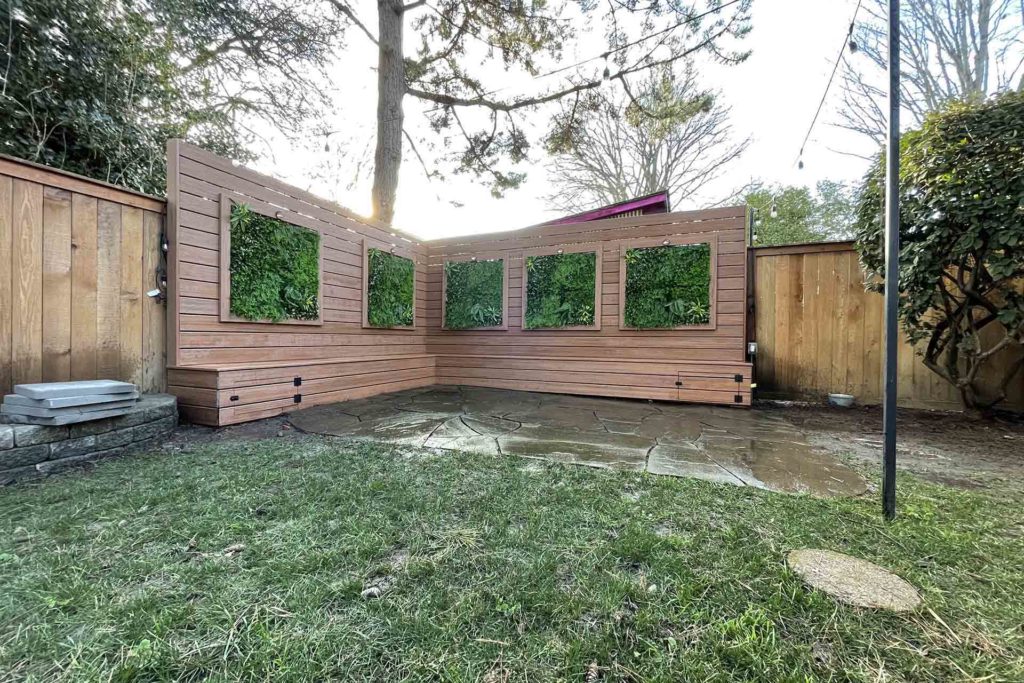 New wooden fence in the backyard with hanging garden panels on it